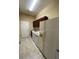The laundry room features a front-loading washer and dryer, cabinets, and a white refrigerator at 12619 50Th E Ct, Parrish, FL 34219