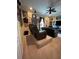 Relaxing living room with a comfortable reclining sofa, ceiling fan, and an entertainment center at 12619 50Th E Ct, Parrish, FL 34219