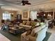 Comfortable living room featuring sofas, ceiling fan, decor and view of kitchen and dining area at 12619 50Th E Ct, Parrish, FL 34219