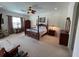 Spacious main bedroom featuring a four-poster bed, ceiling fan, and ample natural light at 12619 50Th E Ct, Parrish, FL 34219