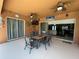 Spacious outdoor patio features a ceiling fan, dining table and chairs, and a grill at 12619 50Th E Ct, Parrish, FL 34219