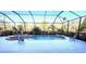 Outdoor pool features clear blue water, a spa, and lounge chairs for relaxing by the pool at 12619 50Th E Ct, Parrish, FL 34219