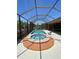 Outdoor pool features clear blue water, a spa, and lounge chairs for relaxing by the pool at 12619 50Th E Ct, Parrish, FL 34219