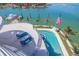 Aerial view of home with a pool and lounge chairs overlooking the scenic water views at 12650 7Th E St, Treasure Island, FL 33706