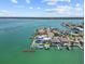 Panoramic aerial shot showcases waterfront estate, boat dock, 135ft yacht, and beautiful landscaping at 12650 7Th E St, Treasure Island, FL 33706