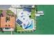 Breathtaking aerial view of a luxurious waterfront property featuring a modern design, private dock, and stunning pool area at 12650 7Th E St, Treasure Island, FL 33706