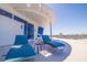 Modern balcony with lounge chairs offers an ideal space for relaxation, boasting stunning views of the water and clear blue skies at 12650 7Th E St, Treasure Island, FL 33706