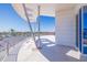 Spacious balcony with sleek railings offers stunning water views, providing a perfect spot for relaxation and entertainment at 12650 7Th E St, Treasure Island, FL 33706