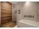 Modern bathroom features a soaking tub, tile backsplash, and a separate shower stall at 12650 7Th E St, Treasure Island, FL 33706