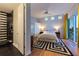 A well-lit bedroom features hardwood floors, a ceiling fan, and ensuite bathroom at 12650 7Th E St, Treasure Island, FL 33706