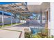 A covered carport features modern design with solar panels and a beautiful koi pond, blending sustainability with style at 12650 7Th E St, Treasure Island, FL 33706