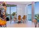 The formal dining area has water views, modern lighting and comfortable seating at 12650 7Th E St, Treasure Island, FL 33706