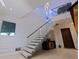 Bright entryway with glass stair railing and unique textured wall at 12650 7Th E St, Treasure Island, FL 33706