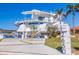 Striking modern residence features a bold exterior design with unique architectural details and meticulous landscaping at 12650 7Th E St, Treasure Island, FL 33706
