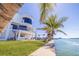 Waterfront home boasting lush grass, waterfront access and contemporary architecture with a private dock and pool at 12650 7Th E St, Treasure Island, FL 33706