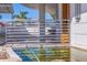 Modern home exterior featuring decorative water feature, modern landscaping, and unique architectural details at 12650 7Th E St, Treasure Island, FL 33706