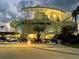 Stunning waterfront home with modern architectural design, creative gate art, and illuminated for evening ambiance at 12650 7Th E St, Treasure Island, FL 33706