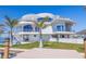 Modern waterfront home showcasing architectural design, outdoor living spaces, and lush landscaping at 12650 7Th E St, Treasure Island, FL 33706