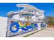 Stunning modern home with a colorful art gate, clean lines, and eye-catching architectural details at 12650 7Th E St, Treasure Island, FL 33706