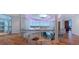 Elegant foyer with glass railings, hardwood floors, and a modern chandelier at 12650 7Th E St, Treasure Island, FL 33706