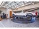 Spacious garage featuring a car turntable and a white truck, with a glass garage door providing lots of natural light at 12650 7Th E St, Treasure Island, FL 33706