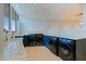 Spacious laundry room with modern appliances, countertops and cabinets for storage at 12650 7Th E St, Treasure Island, FL 33706