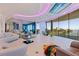 Expansive living room with floor-to-ceiling windows and contemporary decor at 12650 7Th E St, Treasure Island, FL 33706