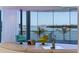 Stylish living room with floor-to-ceiling windows and water views provides an abundance of natural light and a stunning backdrop at 12650 7Th E St, Treasure Island, FL 33706
