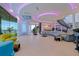 Large living room with modern curved furniture, colorful decor and views of the ocean at 12650 7Th E St, Treasure Island, FL 33706
