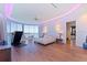 Spacious main bedroom featuring floor-to-ceiling windows, water views, and modern lighting at 12650 7Th E St, Treasure Island, FL 33706