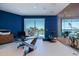 Bright office space with modern glass desk, water view, and tile floors at 12650 7Th E St, Treasure Island, FL 33706