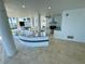 Spacious outdoor kitchen features modern appliances, granite counters, and waterfront views at 12650 7Th E St, Treasure Island, FL 33706
