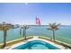 Poolside view shows a pool with the American flag and water views at 12650 7Th E St, Treasure Island, FL 33706