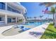 Backyard swimming pool with built-in lounge chairs and view of the waterway at 12650 7Th E St, Treasure Island, FL 33706