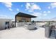 This rooftop kitchen features stainless steel appliances, a bar, and a built-in grill, perfect for outdoor entertaining at 12650 7Th E St, Treasure Island, FL 33706
