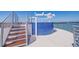 Gorgeous rooftop featuring a blue tiled spa with a white pergola overlooking the beautiful water views at 12650 7Th E St, Treasure Island, FL 33706