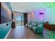 Modern theater room features curved seating, projector, and ambient lighting at 12650 7Th E St, Treasure Island, FL 33706