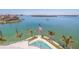 A waterfront view with palm trees, an American flag, and serene water views at 12650 7Th E St, Treasure Island, FL 33706