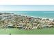 Expansive aerial view of a waterfront community and beachfront showcasing the idyllic coastal living experience at 13313 3Rd E St, Madeira Beach, FL 33708