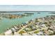 An aerial view highlights the waterfront neighborhood, turquoise waters, and calm community at 13313 3Rd E St, Madeira Beach, FL 33708