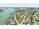A birds eye view shows the property surrounded by charming waterfront homes and calm turquoise waters at 13313 3Rd E St, Madeira Beach, FL 33708