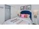 Cozy bedroom featuring a blue headboard, decorative soccer themed decorations, and a closet with ample storage at 13434 Tropical Breeze Way, Hudson, FL 34669