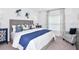 Comfortable bedroom featuring a woven headboard, stylish decor, and soft natural light at 13434 Tropical Breeze Way, Hudson, FL 34669