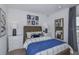 Cozy bedroom with a wood bed frame, coastal decor, and soft neutral colors at 13434 Tropical Breeze Way, Hudson, FL 34669