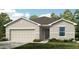 Charming single-story home with a two-car garage, neutral tones, and well-maintained landscaping at 13434 Tropical Breeze Way, Hudson, FL 34669