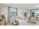 Elegant dining area with a long table and seating for six, complemented by stylish curtains and decorative wall art at 13458 Tropical Breeze Way, Hudson, FL 34669