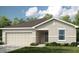 Charming one-story home featuring a two-car garage and well-maintained front yard at 13458 Tropical Breeze Way, Hudson, FL 34669