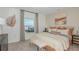 Bright main bedroom with a large window, a cozy king bed, and modern decor at 13458 Tropical Breeze Way, Hudson, FL 34669