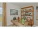Well-designed home office with a modern desk, decorative shelves, and a bright window at 13458 Tropical Breeze Way, Hudson, FL 34669