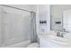 Bathroom featuring a tub, shower combo, white vanity, and neutral colors for a clean and relaxing look at 13478 Tropical Breeze Way, Hudson, FL 34669